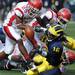 Michigan quarterback Denard Robinson fumbles the ball after trying to scrap out a couple of extra yards against the Delaware State Univeristy defense during second quarter action of the Wolverine's 63-6 thumping of the Hornets, Saturday, October 17th at Michigan Stadium. 
Lon Horwedel | AnnArbor.com